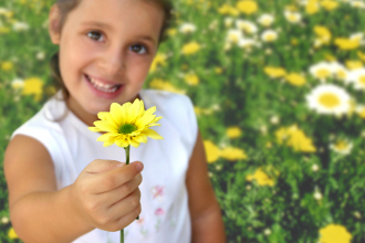 Meist schenken Kinder Blumen zum Muttertag Kind mit Blume in der Hand
